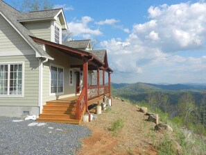 A house with a wooden porch and a view of the mountains. - Among the Peaks | Spectacular Mtn Views+Fire Pit (Bakersville)