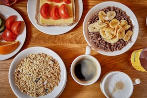 A breakfast setting with cereal, toast, coffee, and a dessert plate.
