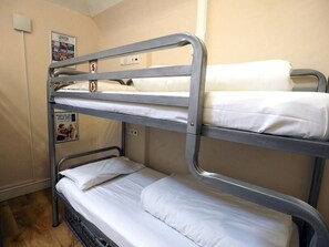 A bunk bed room with three levels, a poster on the wall, and a sign with a number. - St Christopher's Edinburgh Original (Edinburgh)