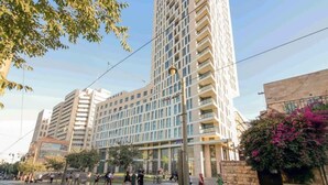 A multi-story hotel with a modern design, featuring a prominent glass facade and a central courtyard. - Cosy 1 bedroom city center (Jerusalem)