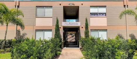 A building with a sign reading "StayAvenida" at the entrance.