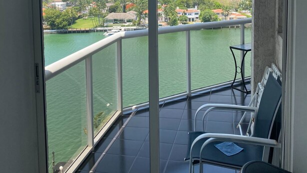 A balcony with a view of a river and cityscape. - Beautifully modern just renovated steps away from the Beach. (Miami Beach)