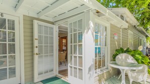 A house with a porch, a table, and a door with a number '6'. - Key West Villas (Key West)