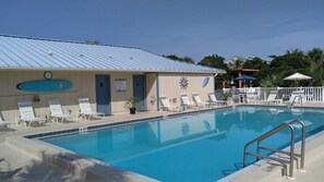 A swimming pool with lounge chairs and a pool rules sign. - Serene #202 Chateau La Mer II 1Bd-1Bath Ground Floor 2 Queen Beds &Sofabed (Destin)