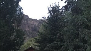 A lodge with a wooden exterior, a porch, and a lit entrance. - Fantastic and Fun “O Canada" Yurt, sleeps 4 (Rigby)