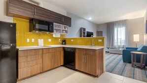A modern kitchen with wooden cabinets, a built-in microwave, and a dishwasher.