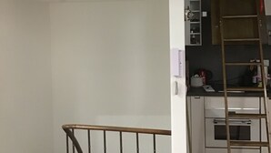 A staircase with a metal railing leading to a landing.