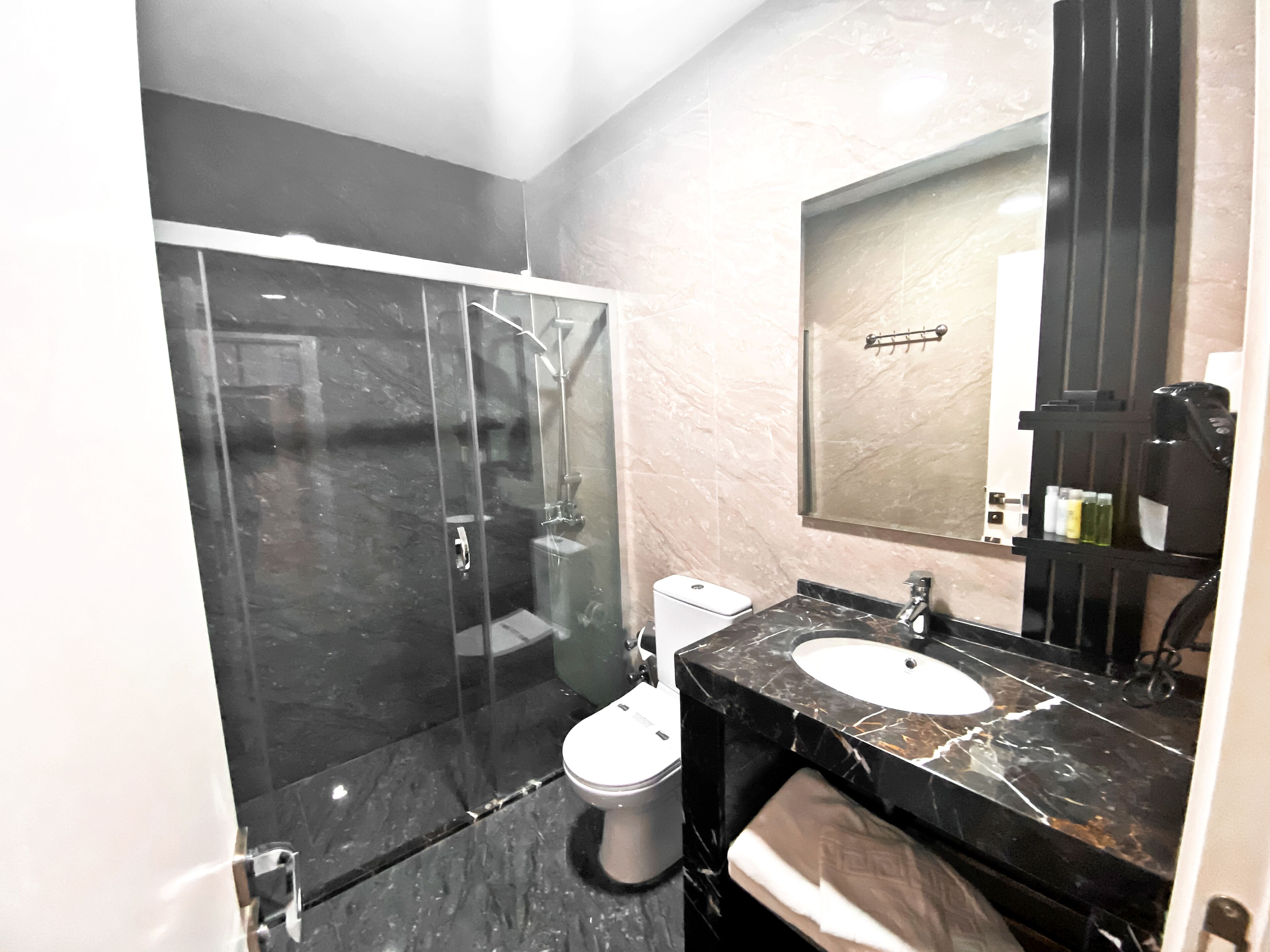economy room, no windows, basement | bathroom | shower, rainfall showerhead, hair dryer, slippers