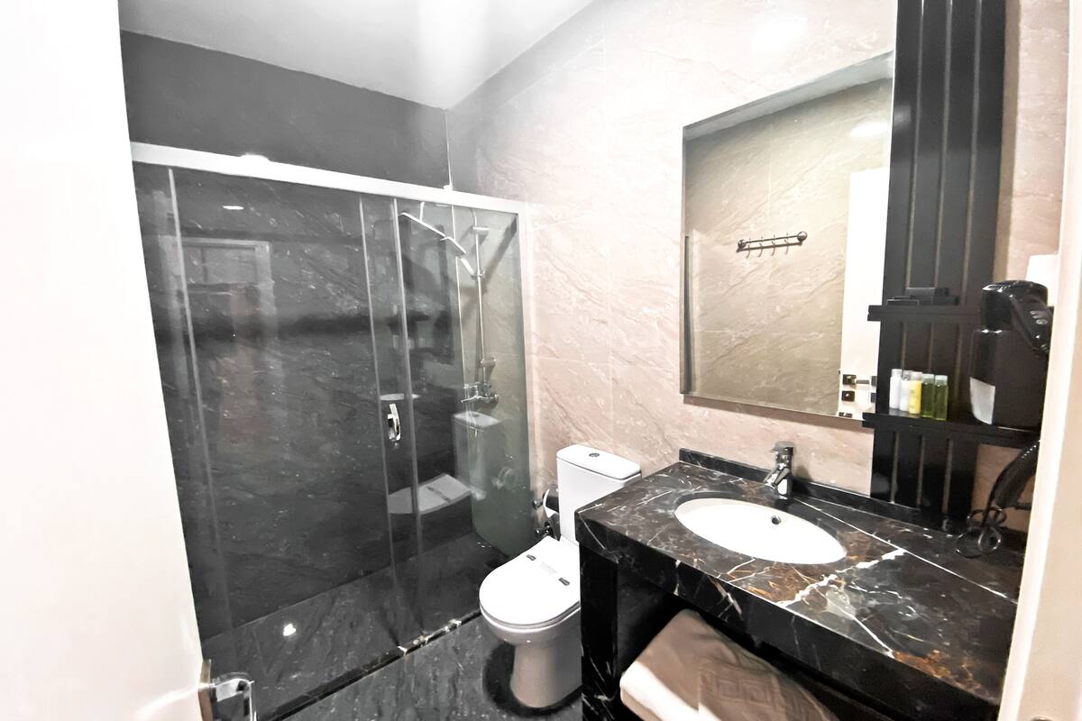 economy room, no windows, basement | bathroom | shower, rainfall showerhead, hair dryer, slippers