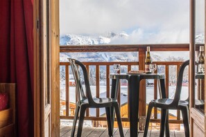 Relax on the balcony with a glass of wine, taking in the breathtaking mountain views.