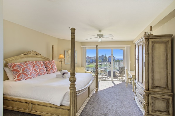 A four-poster bed with a balcony view, a ceiling fan, and a classic wooden wardrobe. - Amalfi Coast 311A - Gulf View, Heated Community Pool, Exercise Room, Tennis! (Miramar Beach)