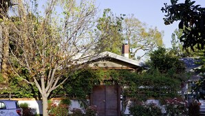 Une maison d’habitation avec un porche à l’avant, un garage et une allée.