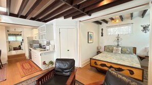 A bedroom with a bed, a desk with a computer, a chair, and a window. - Artistic Haven in Hollywood with Pool, Hot Tub, Cabana, and Garden (Los Angeles)