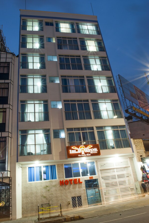 A multi-story hotel building with a sign indicating it is a hotel.