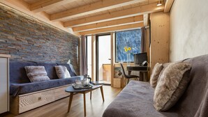 A cozy room with a blue sofa, a wooden coffee table, and a grey sofa. - Grand Roc C411 280m from Slopes, Mont-Blanc View, Parking & WiFi, Argentière (Chamonix), France (Argentière (Chamonix))