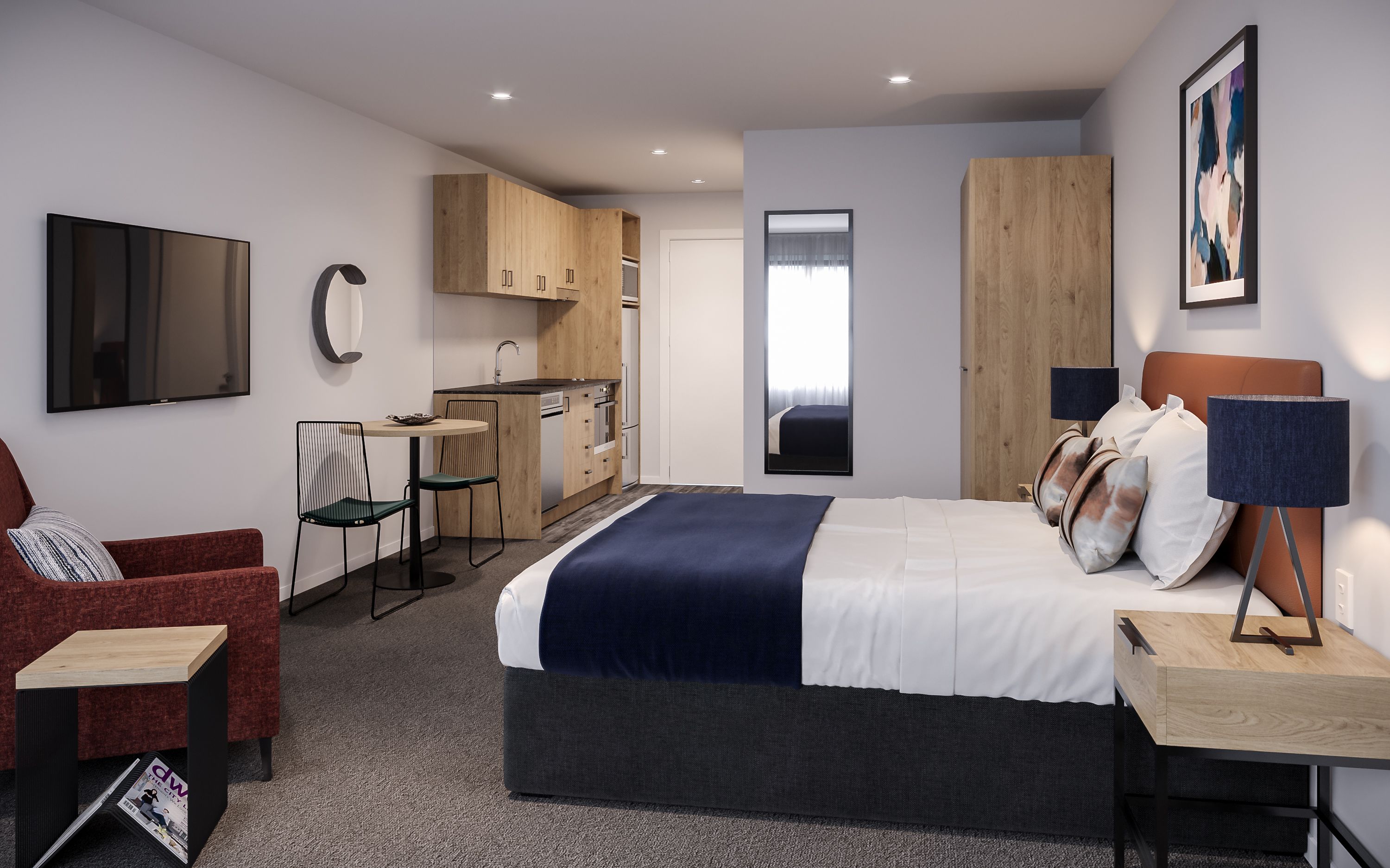 A modern hotel room with a bed, a desk, a chair, a TV, a kitchen area, and a large window.