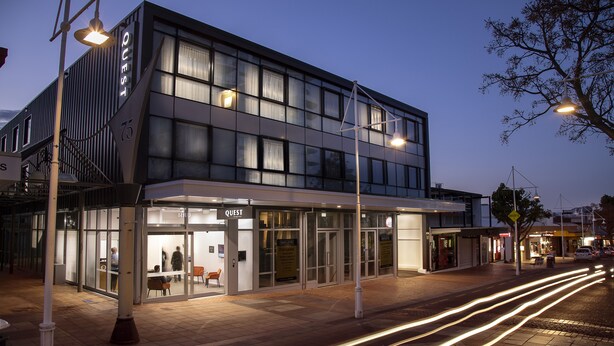A modern building with a glass facade, a visible entrance, and a sign that reads "QUEST". - Quest Tauranga Central (Tauranga)