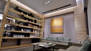 A modern living room with a built-in bookshelf, a sofa, and a coffee table. - The 123 B&B (Ji'an)