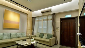 A modern living room with a sofa set, a coffee table, and an air conditioning unit. - The 123 B&B (Ji'an)
