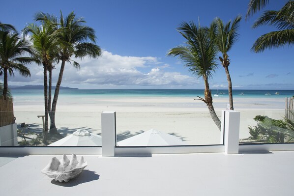 On the beach, white sand, sun loungers, beach umbrellas