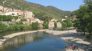 Enjoy serene views of the meandering river surrounded by lush greenery and traditional stone buildings.