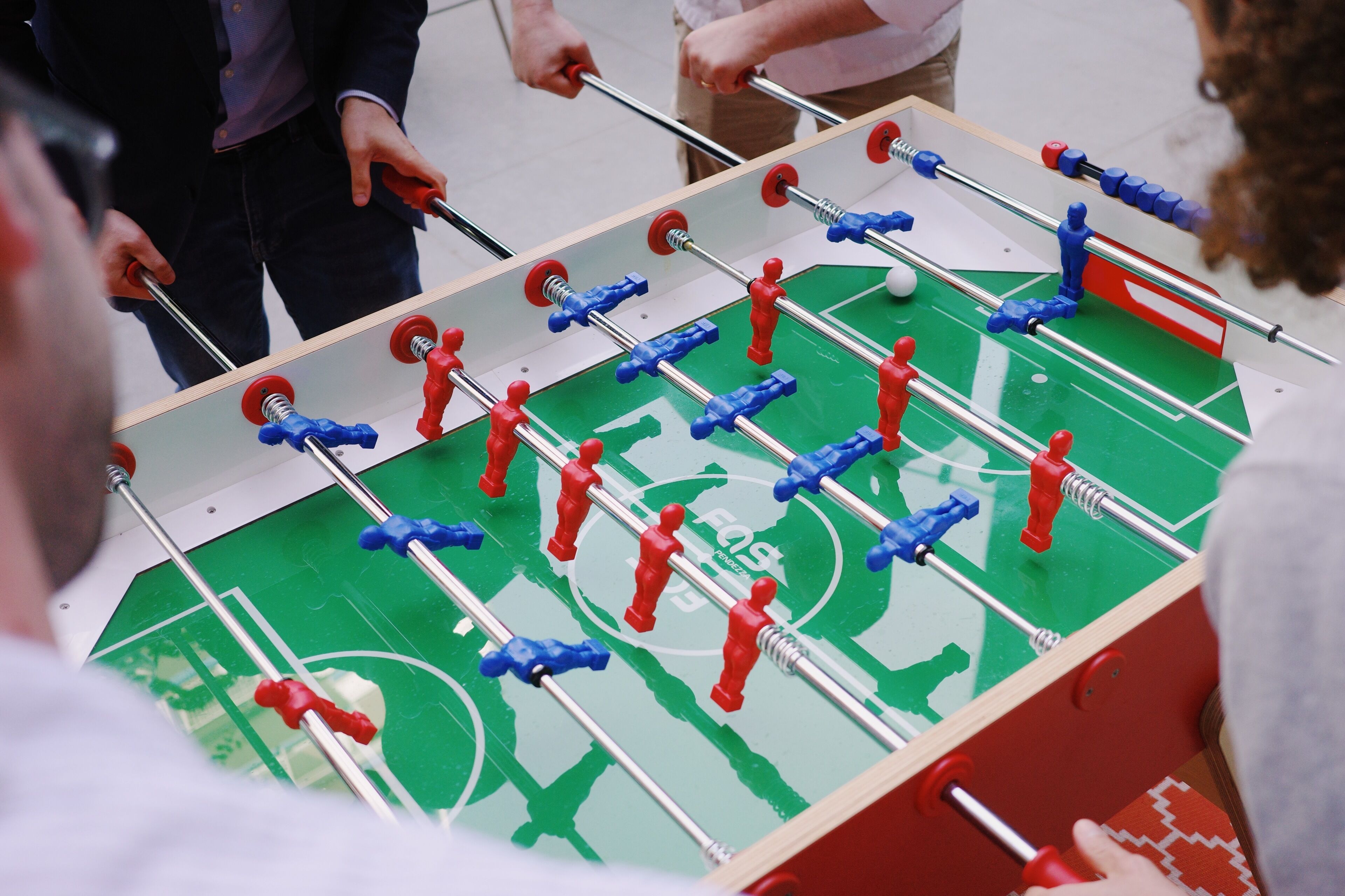 A foosball table with red and blue players.