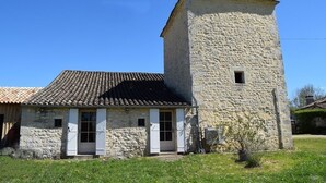 A stone building with a tiled roof and a small tower. - Pretty dovecote in the countryside (monestier)