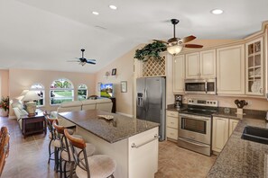 Enjoy cooking in this well-lit kitchen with a large island and stainless steel appliances.