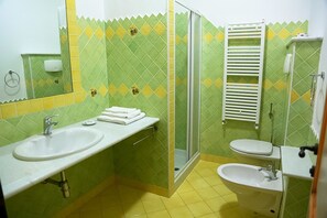 A bathroom with two sinks, a shower, and a toilet. - Melalidone (Orosei)