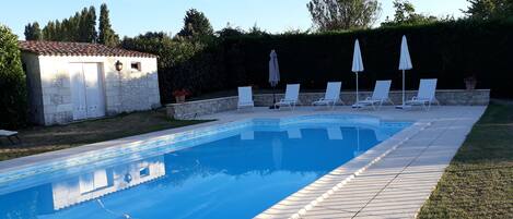 Seasonal outdoor pool, open 10:30 AM to 8:00 PM, pool loungers