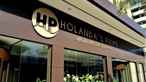 A modern building with a prominent HP logo and the name "HOLANDA'S PRIME SHOPPING RESIDENCE". - Holanda's Prime - Praia de Tambaú (João Pessoa)