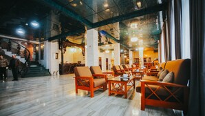 A spacious lobby with a marble floor, wooden furniture, and a staircase leading to upper levels. - Hotel Wine Palace (Tbilisi)