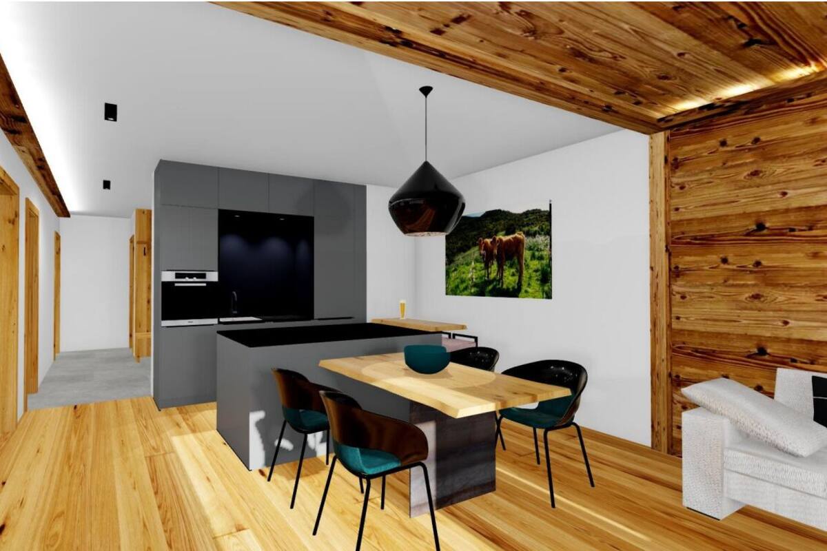 A modern kitchen with a central island, wooden flooring, and a dining area with chairs.