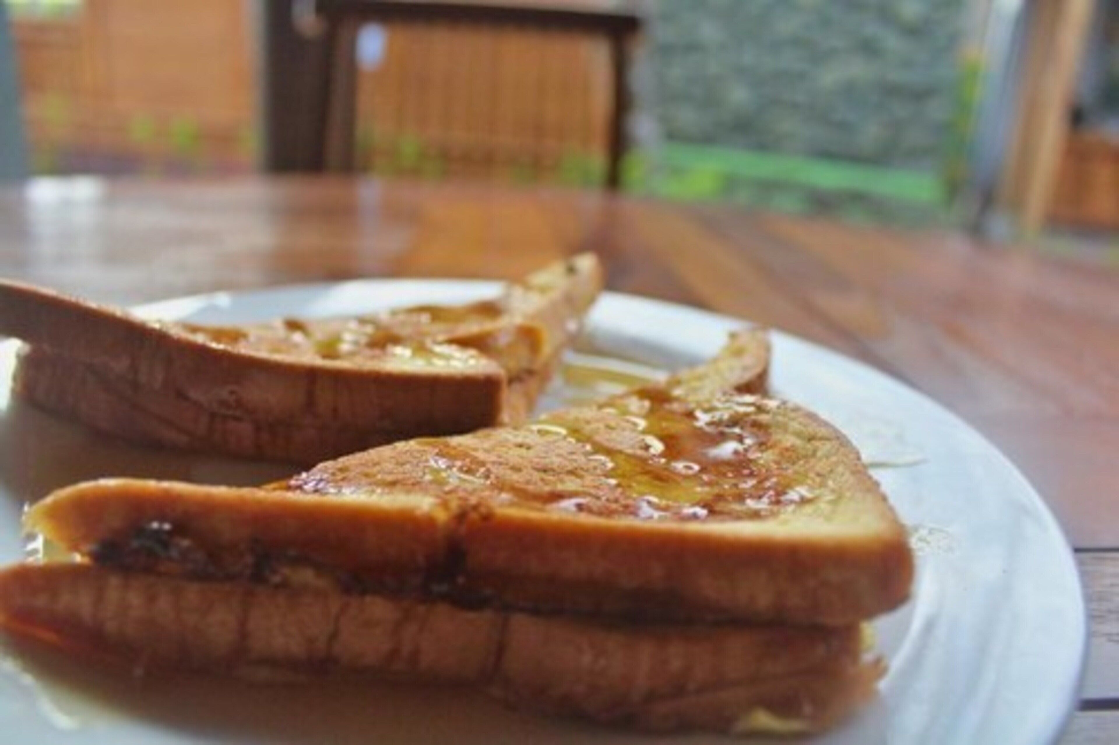 A plate of toast with butter and jam.