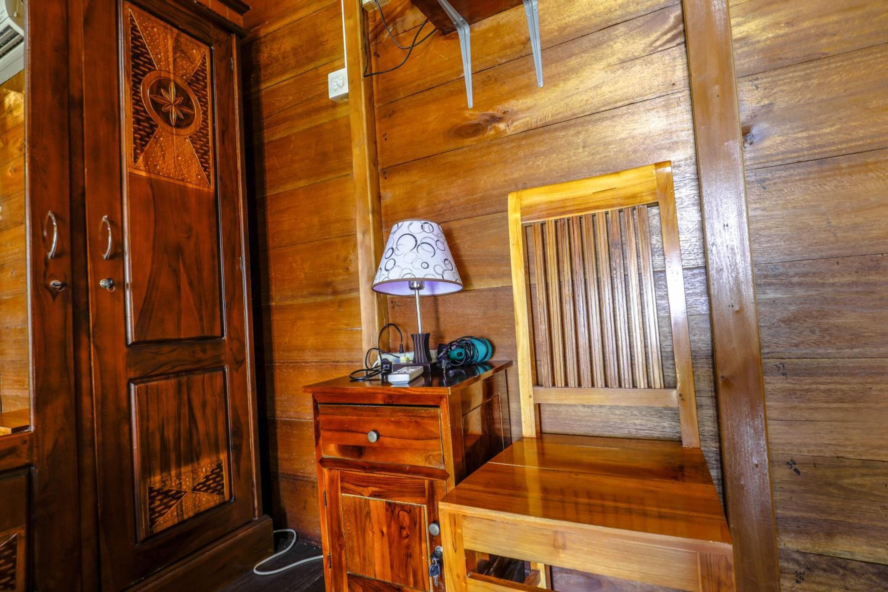A wooden interior with a desk, chair, and cabinet.