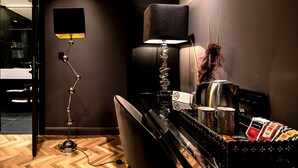 A modern hotel room with a wooden floor, a black desk with a kettle, a lamp, and a sign indicating no smoking. - Artale 07 - Adults Only (Split)