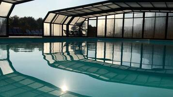 Indoor pool, outdoor pool, pool umbrellas, pool loungers