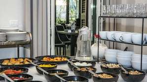 A breakfast buffet with various food items and utensils. - Villa Elisio Hotel & Spa (Naples)