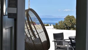 A wicker chair with a view of the sea and mountains. - Kallos Imar Boutique Hotel  (Santorini)