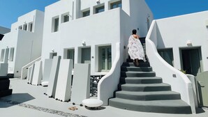 A modern white building with a staircase leading to a door marked "201". - Kallos Imar Boutique Hotel  (Santorini)