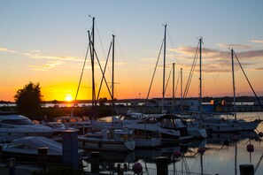 A marina with multiple boats docked at sunset.