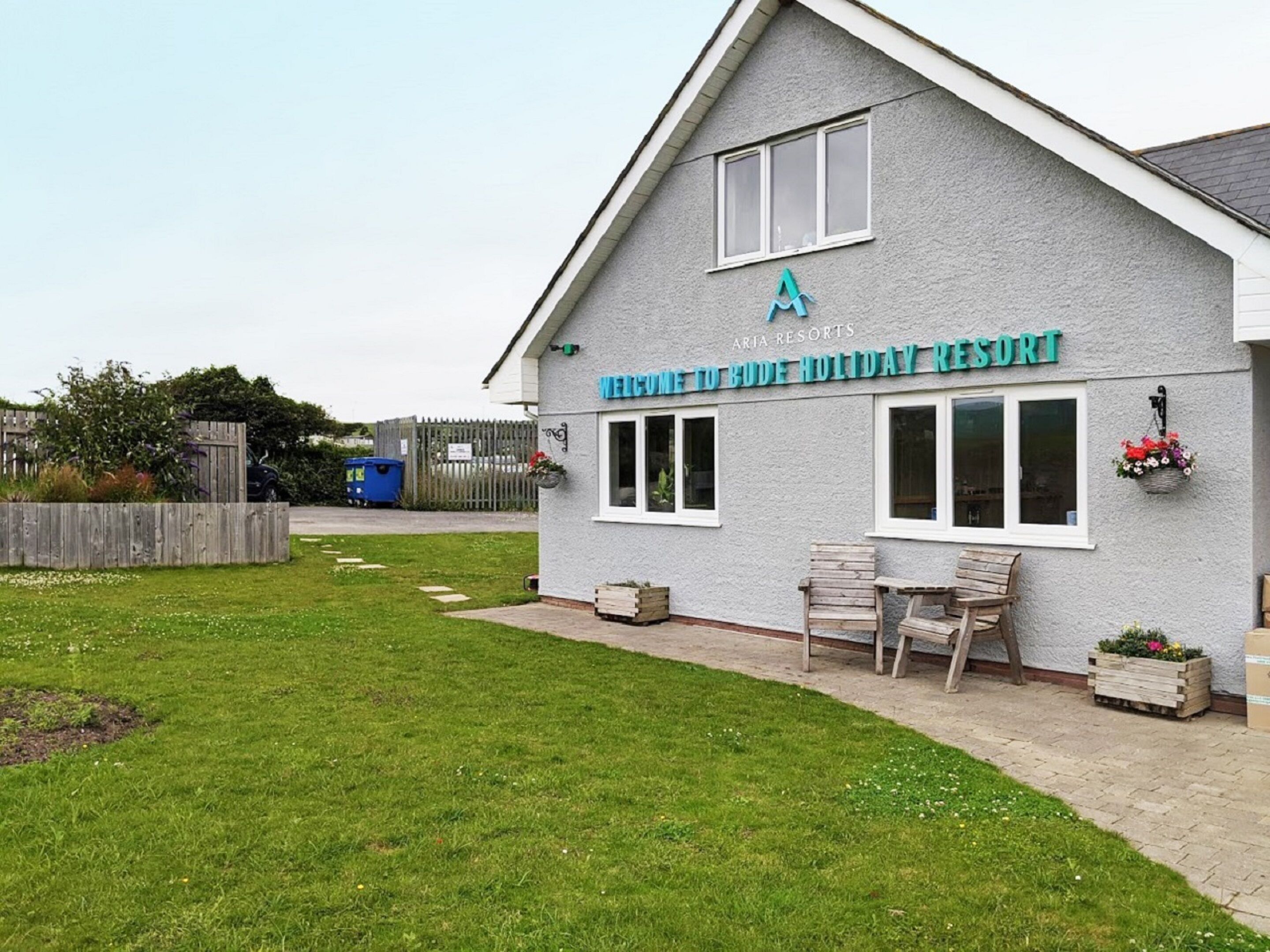 A building with a sign reading "Welcome to Bude Holiday Resort".