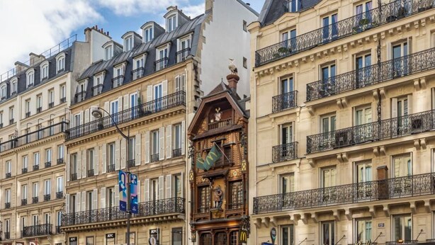 A row of classic European-style buildings with uniform balconies and traditional architecture.