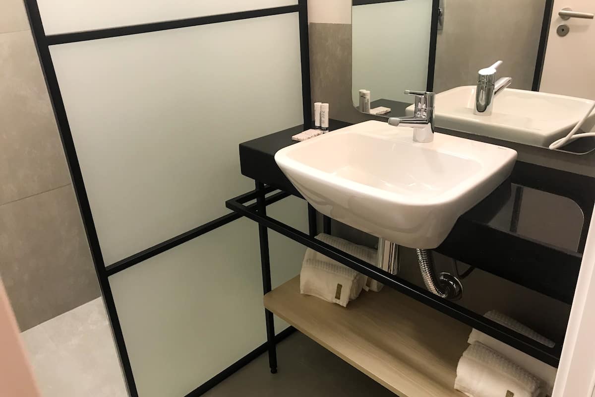 shower, designer toiletries, hair dryer, towels