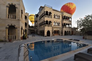 Seasonal outdoor pool, open 11:00 AM to 7:00 PM, pool umbrellas
