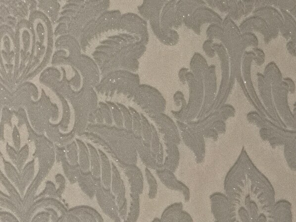 A close-up of a textured fabric with a paisley pattern.