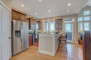 Dishwasher, coffee/tea maker, cookware/dishes/utensils, dining tables