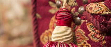 A close-up of a decorative tassel hanging from a fabric with a floral pattern.