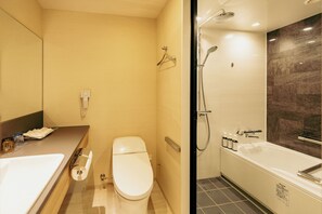 A modern bathroom with a toilet, sink, and bathtub. - Hotel JAL City Sapporo Nakajima Park (Sapporo)