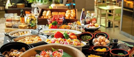 A buffet with various food items and condiments.